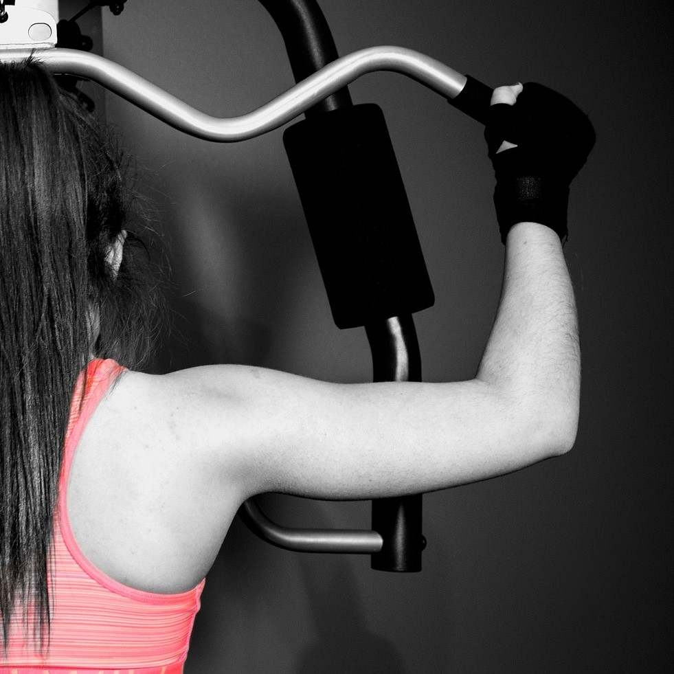 A girl doing pull downs